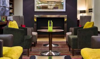 Lobby workspace by the fireplace at the Hampton by Hilton London Luton Airport.