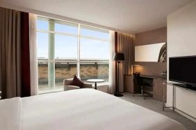 beautiful king suite with TV, work desk, and lounge at Hilton London Angel Islington.