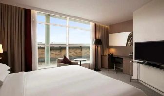 beautiful king suite with TV, work desk, and lounge at Hilton London Angel Islington.