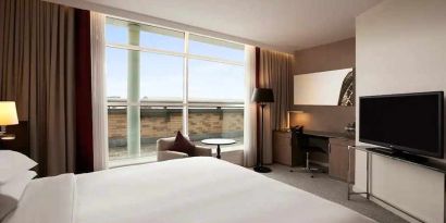 beautiful king suite with TV, work desk, and lounge at Hilton London Angel Islington.