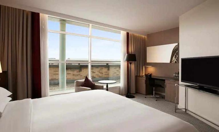 beautiful king suite with TV, work desk, and lounge at Hilton London Angel Islington.