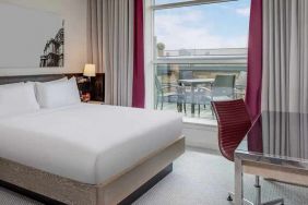 comfortable delux king bed with lots of natural light, work desk, and outside terrace at Hilton London Angel Islington.