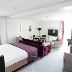 luxurious king suite with lounge area and work desk at Hilton London Angel Islington.