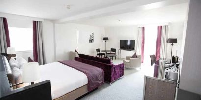 luxurious king suite with lounge area and work desk at Hilton London Angel Islington.