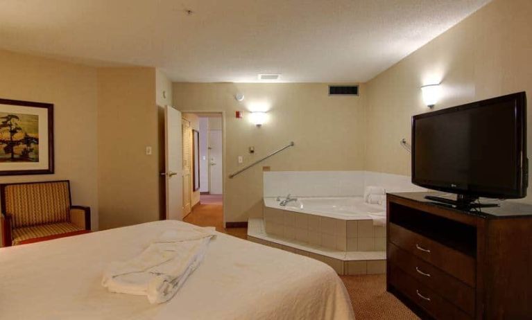 King size bed with jacuzzi and television at Hilton Garden Inn Calgary Airport