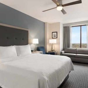 spacious king suite with work area and TV at Homewood Suites by Hilton University City Philadelphia, PA.