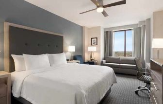 spacious king suite with work area and TV at Homewood Suites by Hilton University City Philadelphia, PA.