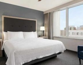 comfortable king bed with lots of natural light at Homewood Suites by Hilton University City Philadelphia, PA.