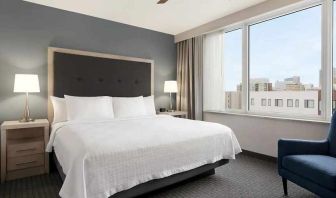 comfortable king bed with lots of natural light at Homewood Suites by Hilton University City Philadelphia, PA.