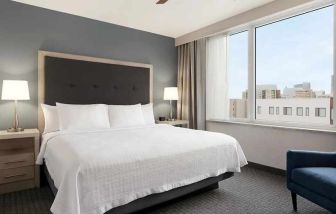 comfortable king bed with lots of natural light at Homewood Suites by Hilton University City Philadelphia, PA.