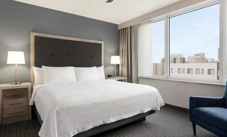 comfortable king bed with lots of natural light at Homewood Suites by Hilton University City Philadelphia, PA.