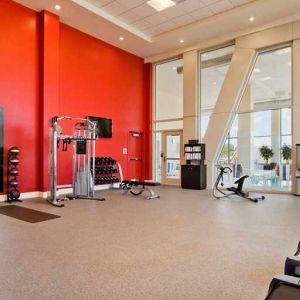 well equipped fitness center with natural light at Homewood Suites by Hilton University City Philadelphia, PA.