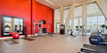 well equipped fitness center with natural light at Homewood Suites by Hilton University City Philadelphia, PA.