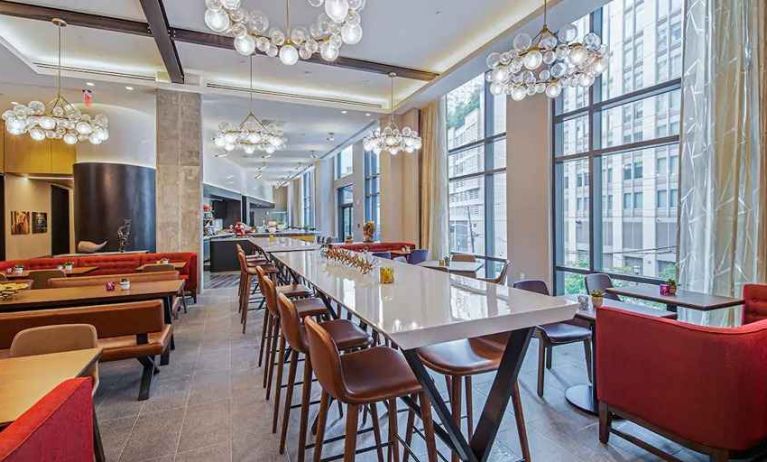 comfortable restaurant and coworking space with lots of natural light at Canopy by Hilton Jersey City Arts District.