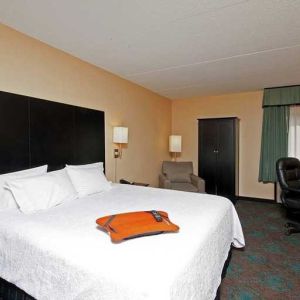 comfortable king room with TV and work desk at Hampton Inn Bloomington.