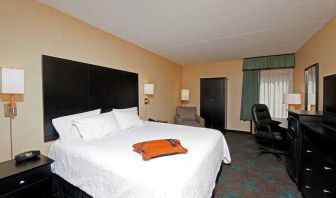 comfortable king room with TV and work desk at Hampton Inn Bloomington.