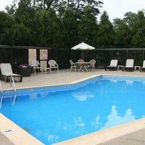 beautiful outdoor pool with seating area and sun beds at Hampton Inn Bloomington.