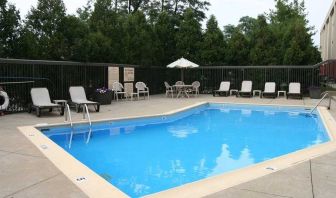 beautiful outdoor pool with seating area and sun beds at Hampton Inn Bloomington.