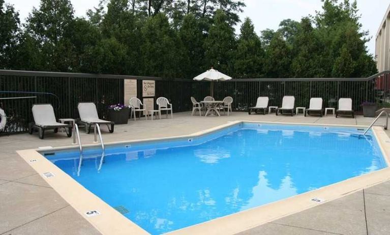 beautiful outdoor pool with seating area and sun beds at Hampton Inn Bloomington.