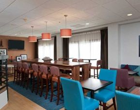 comfortable restaurant and lounge area ideal for coworking at Hampton Inn Bloomington.