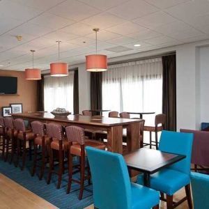 comfortable restaurant and lounge area ideal for coworking at Hampton Inn Bloomington.