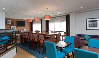 comfortable restaurant and lounge area ideal for coworking at Hampton Inn Bloomington.