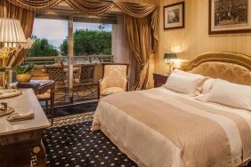 King bedroom with balcony at the Rome Cavalieri, A Waldorf Astoria Hotel.