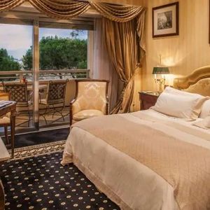 King bedroom with balcony at the Rome Cavalieri, A Waldorf Astoria Hotel.