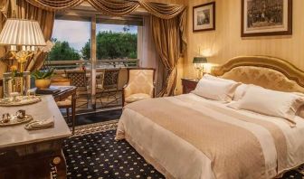 King bedroom with balcony at the Rome Cavalieri, A Waldorf Astoria Hotel.