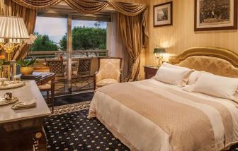 King bedroom with balcony at the Rome Cavalieri, A Waldorf Astoria Hotel.