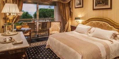 King bedroom with balcony at the Rome Cavalieri, A Waldorf Astoria Hotel.