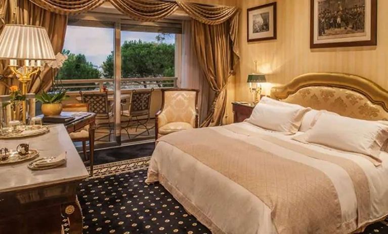 King bedroom with balcony at the Rome Cavalieri, A Waldorf Astoria Hotel.