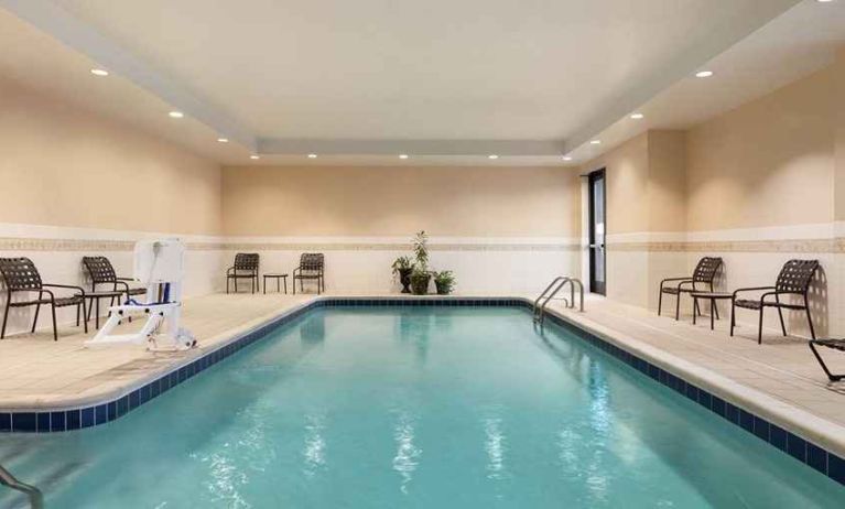 large indoor pool with surrounding seating area at Hilton Garden Inn Troy.