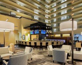 spacious lobby and coworking space ideal for digital nomads at Embassy Suites by Hilton Detroit Troy Auburn Hills.
