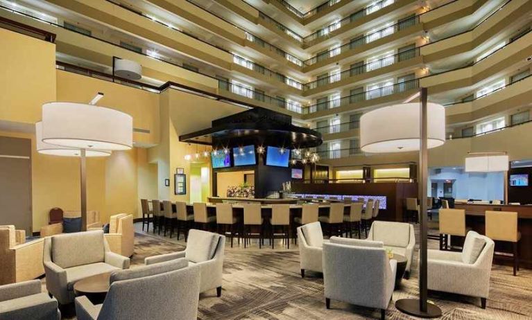 spacious lobby and coworking space ideal for digital nomads at Embassy Suites by Hilton Detroit Troy Auburn Hills.