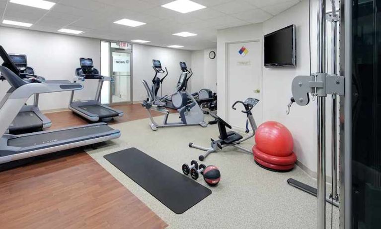 fitness center well equipped with treadmills and weights at Embassy Suites by Hilton Detroit Troy Auburn Hills.