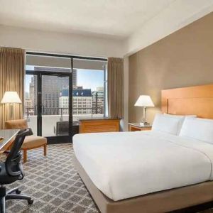 spacious king suite with work desk and city views at Hilton San Francisco Financial District.