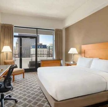 spacious king suite with work desk and city views at Hilton San Francisco Financial District.