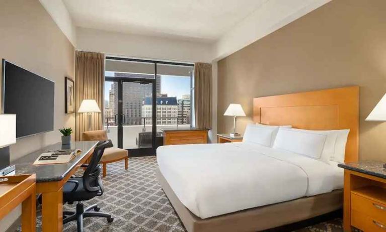 spacious king suite with work desk and city views at Hilton San Francisco Financial District.