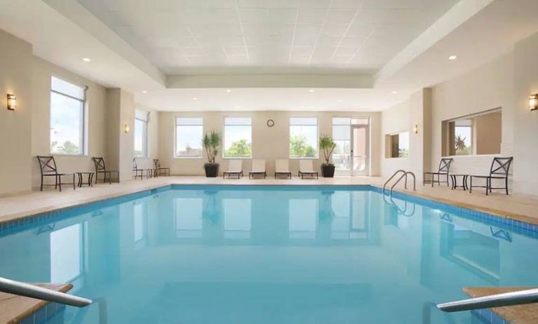 lovely indoor pool with surrounding seating area at Embassy Suites by Hilton Oklahoma City Downtown Medical Center.