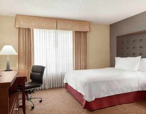 spacious king room with TV and work desk ideal for working remotely at Homewood Suites by Hilton Oakland-Waterfront.