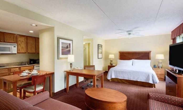 beautiful and spacious king bedroom with work desk, lounge area, and kitchenette at Homewood Suites by Hilton Newark-Wilmington South Area.