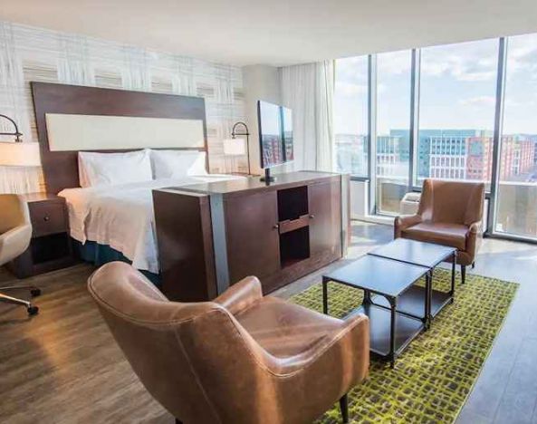 spacious king suite with TV, lounge, and work desk at Hampton Inn & Suites Washington DC-Navy Yard.