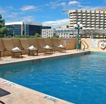 luxurious outdoor pool surrounded by sunbeds at DoubleTree by Hilton Hotel Albuquerque.