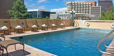 luxurious outdoor pool surrounded by sunbeds at DoubleTree by Hilton Hotel Albuquerque.