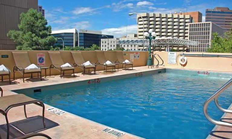 luxurious outdoor pool surrounded by sunbeds at DoubleTree by Hilton Hotel Albuquerque.