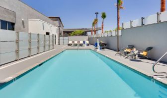 large outdoor pool with sunbeds and outdoor seating at Hampton Inn Irvine Spectrum Lake Forest.