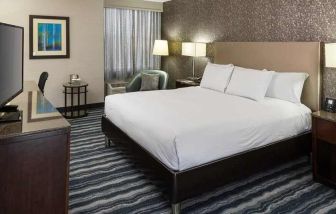 comfortable king room with TV and work desk ideal for working remotely at DoubleTree by Hilton Hotel Wilmington.