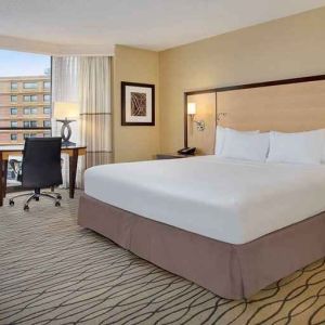 spacious king room with TV and work area ideal for working remotely at Hilton Rosemont/Chicago O'Hare.