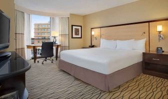 spacious king room with TV and work area ideal for working remotely at Hilton Rosemont/Chicago O'Hare.